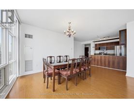 A dining room with a wooden table and chairs.