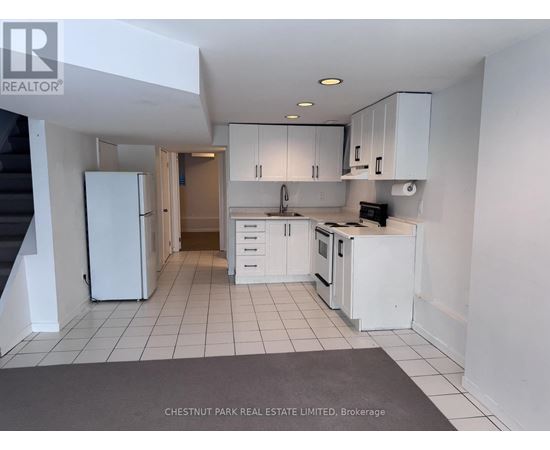 A kitchen with white appliances and cabinets is shown.