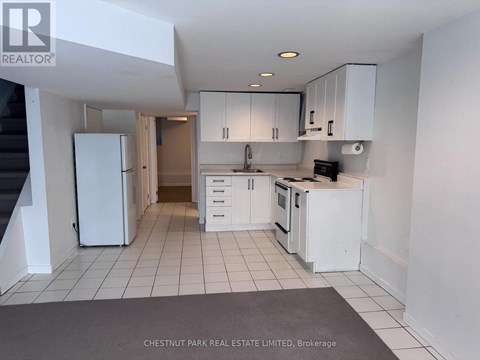 A kitchen with white appliances and cabinets is shown.