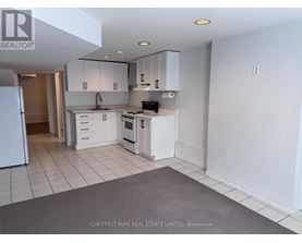 A kitchen with white appliances and cabinets is on the market with Chestnut Park Real Estate Limited.