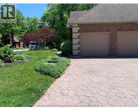 A house with a driveway and garage in front of it.