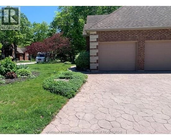 A house with a driveway and garage in front of it.