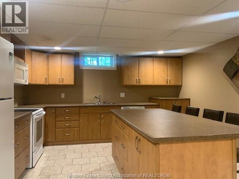 A kitchen with wooden cabinets and a granite countertop.