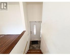 A white door in a room with a wooden floor.