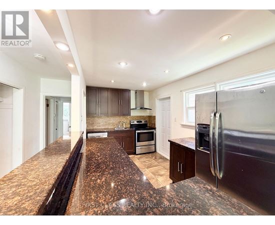 A kitchen with granite countertops and stainless steel appliances.