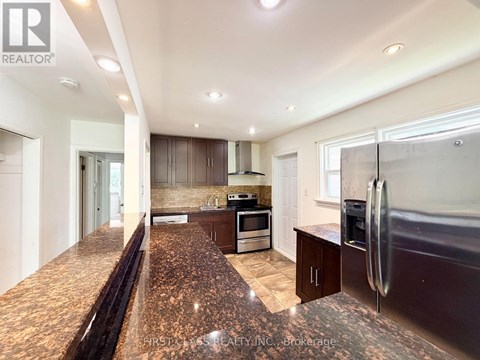 A kitchen with granite countertops and stainless steel appliances.