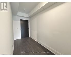 A room with a door at the end of the hallway.