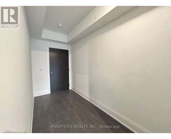 A room with a door at the end of the hallway.
