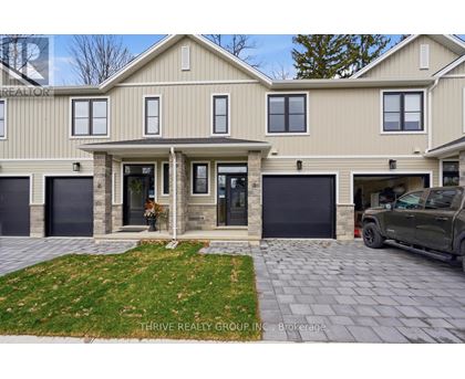 A house with a car parked in front of it.