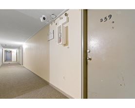 A hallway with a door marked B59 on it.