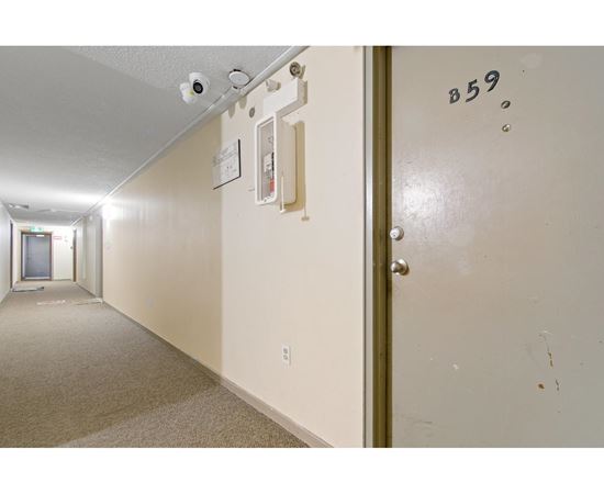 A hallway with a door marked B59 on it.