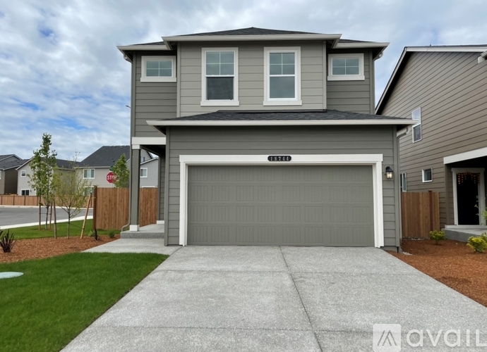 A two-story house with a garage is available for sale.