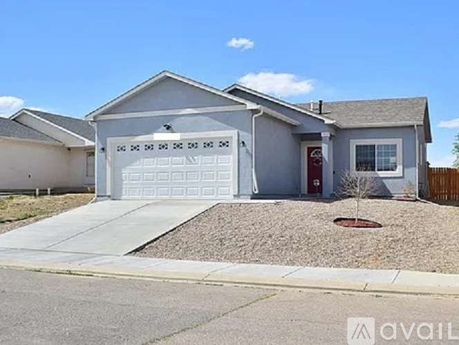 A house with a garage and a driveway in front.