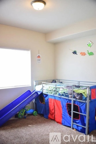 A child's bedroom with a bunk bed and a slide.