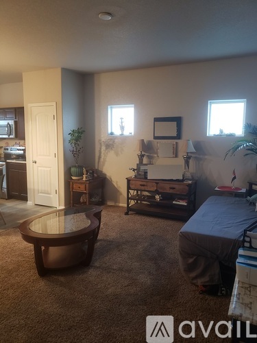 A living room with a brown sofa and a wooden coffee table.