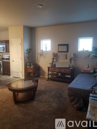 A living room with a brown sofa and a wooden coffee table.