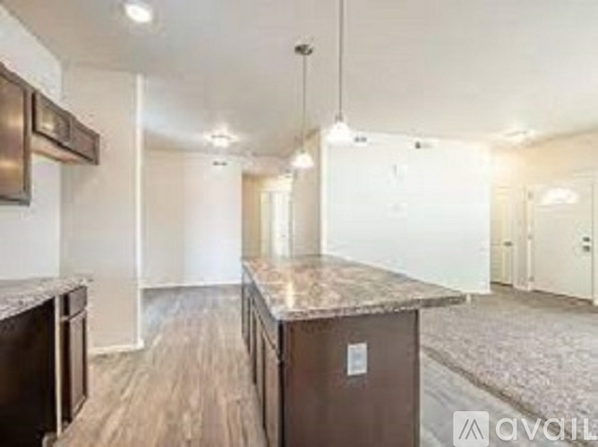 A kitchen area with a counter and cabinets.