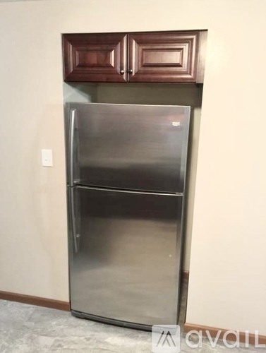A stainless steel refrigerator in a kitchen.