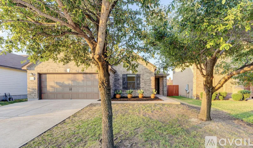 A house with a tree in front of it is for sale.