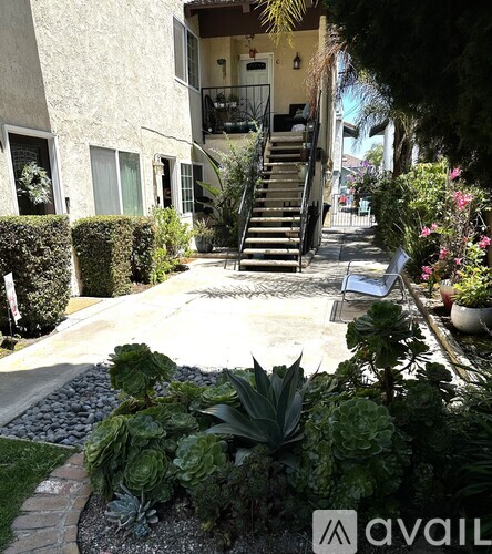 A garden with a stone pathway and a variety of plants.