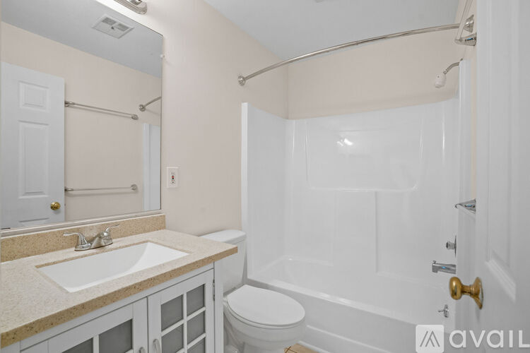 A bathroom with a sink, toilet, and bathtub.