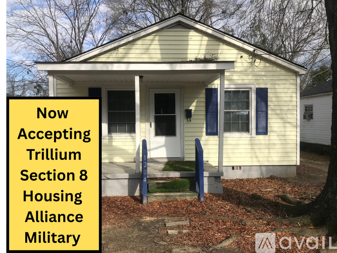 A house with a sign that says "Now Accepting Trillium Section 8 Housing Alliance Military".