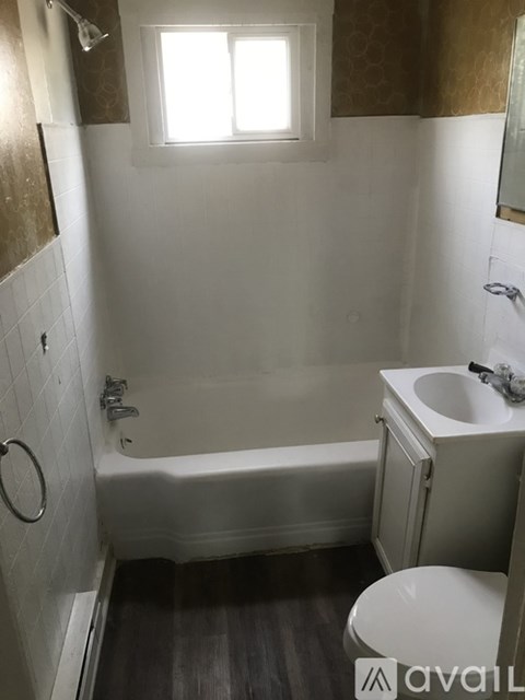 A small white bathroom with a toilet, sink, and bathtub.