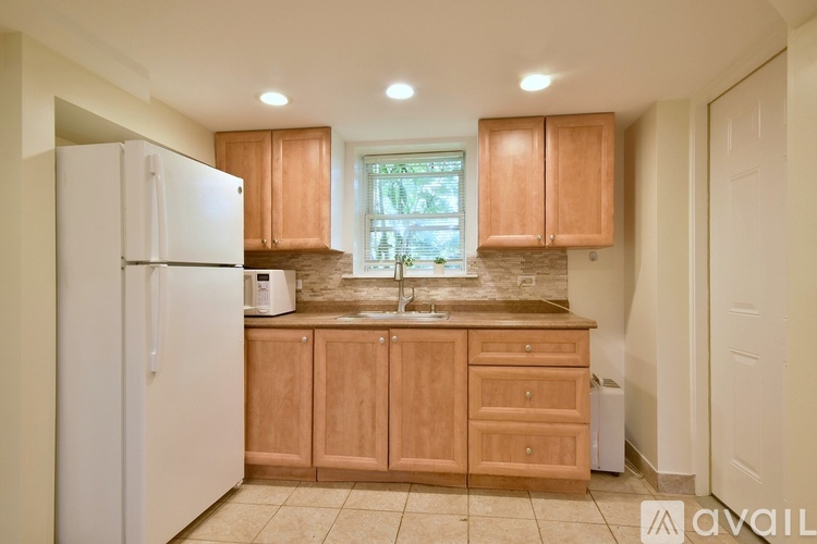 A kitchen with wooden cabinets and a white refrigerator.