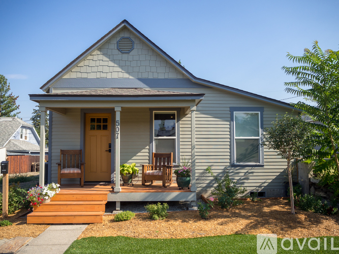 A house with a front porch and a brown door.