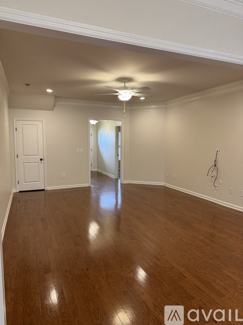 A room with wooden floors and a white door.