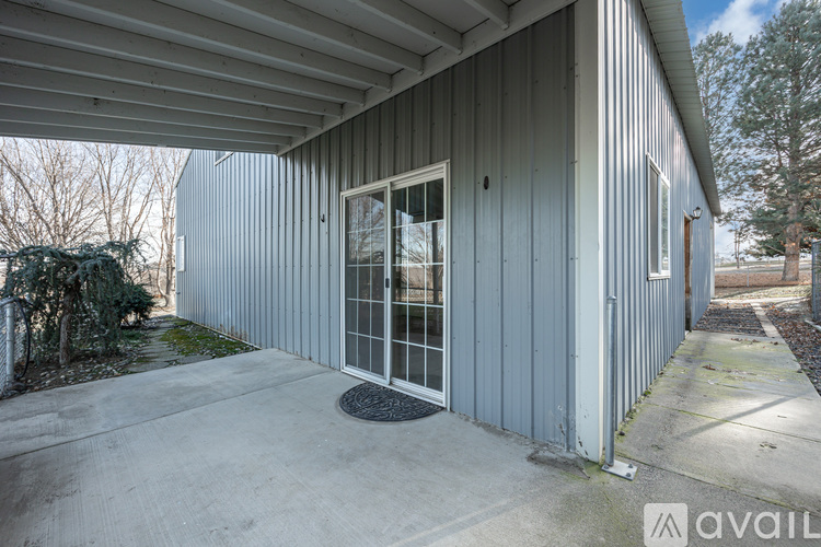 A grey building with a door and windows.