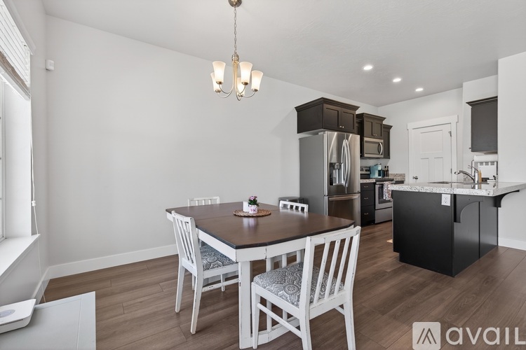 A modern kitchen with a dining table and chairs.