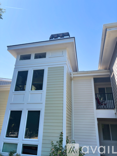 A building with a balcony and a window with a view of the sky.