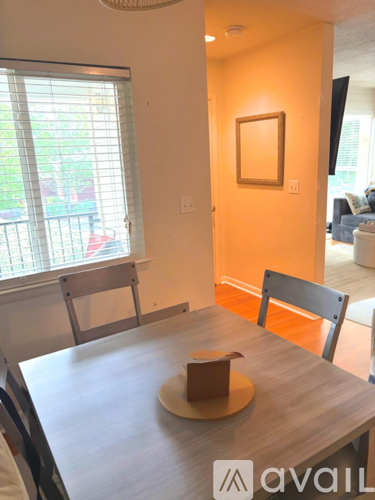 A dining room with a wooden table and chairs.
