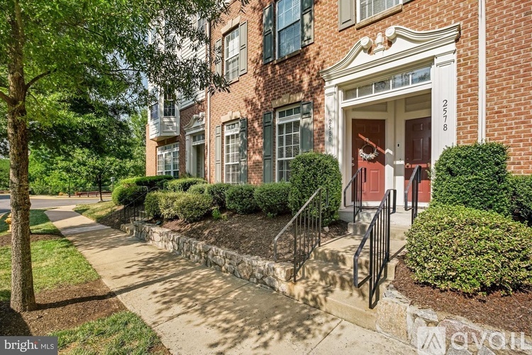 A red door is on the right side of the building.