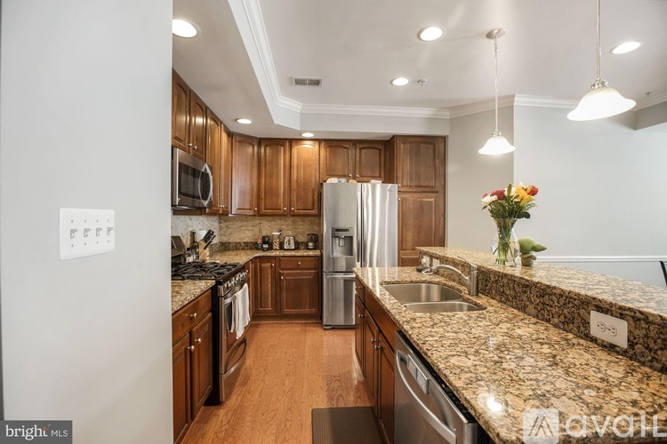 A kitchen with wooden cabinets and granite countertops.