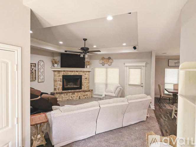 A living room with a fireplace and a white couch.