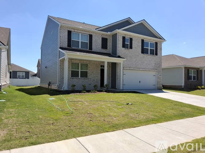 A two-story house with a garage is available for rent.