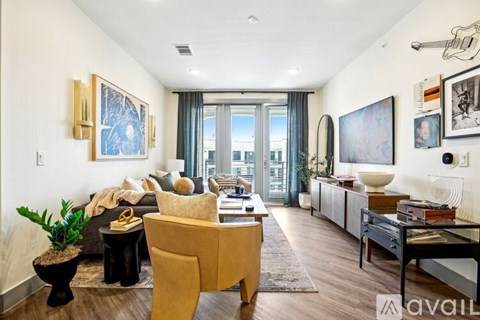 A living room with a yellow chair and a black table.