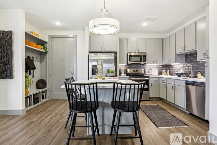 A modern kitchen with a dining table and chairs.