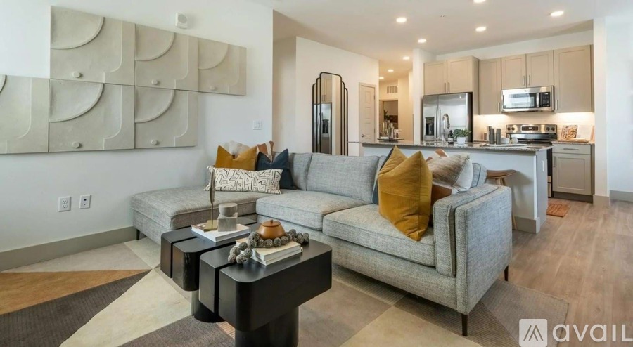 A modern living room with a grey sofa and a coffee table.