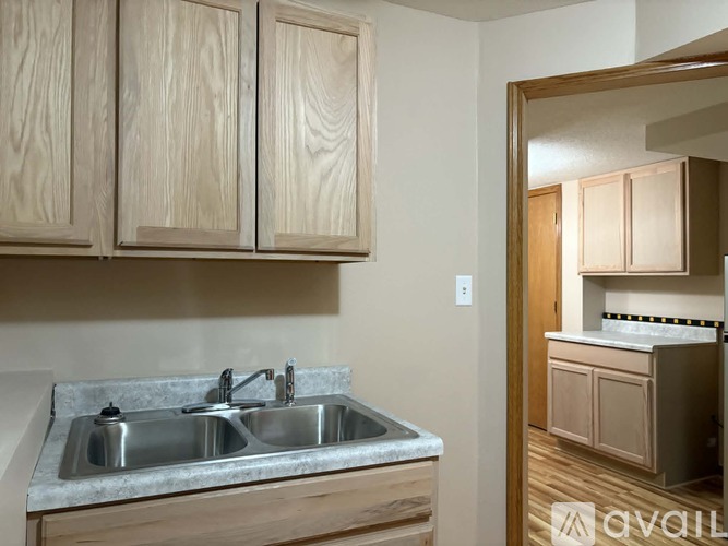 A kitchen with wooden cabinets and a marble countertop.