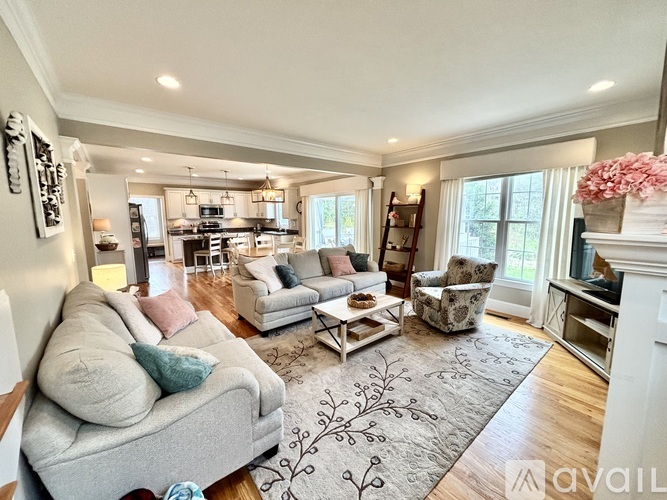 A living room with a grey couch and a coffee table.