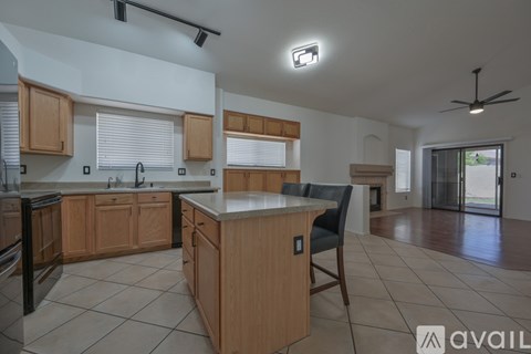 A kitchen with wooden cabinets and a marble countertop.