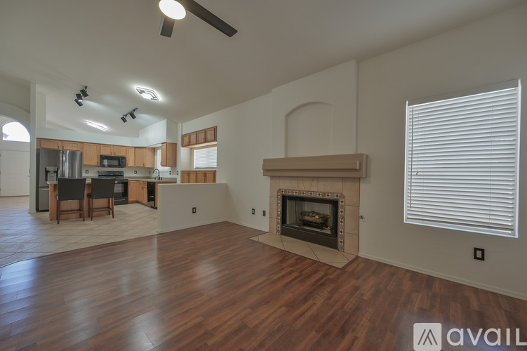 A living room with a fireplace and a dining table.