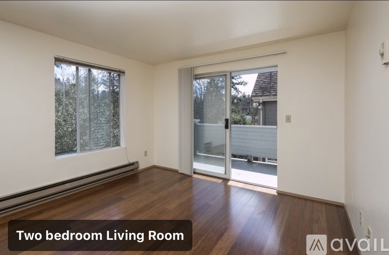 A two bedroom living room with wooden floors and sliding glass doors.
