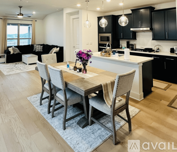 A modern kitchen with a dining table set for four.