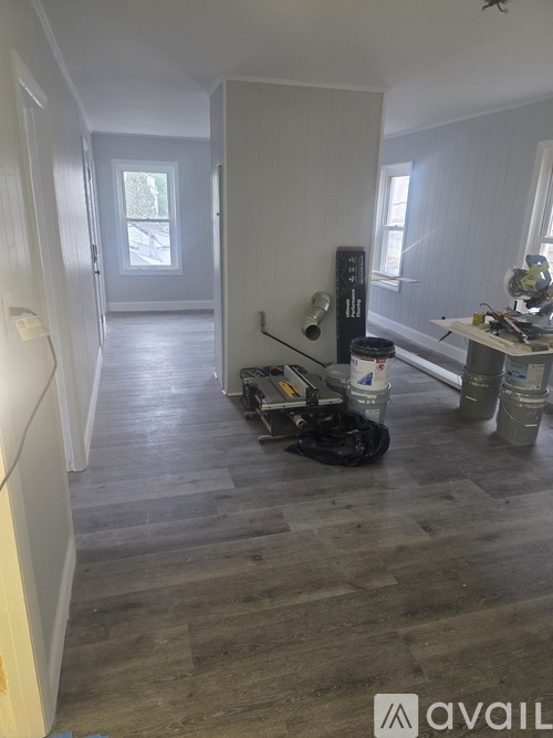 A room with wooden flooring and a white door.
