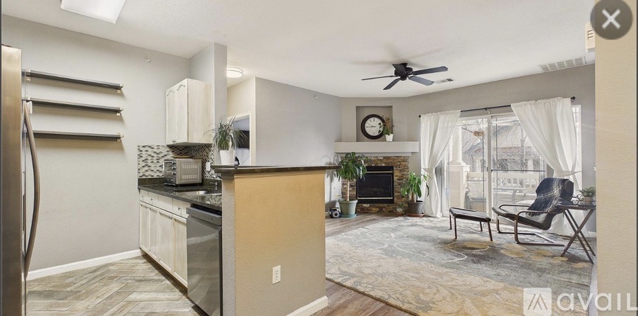 A kitchen with a refrigerator, a stove, and a dining table.