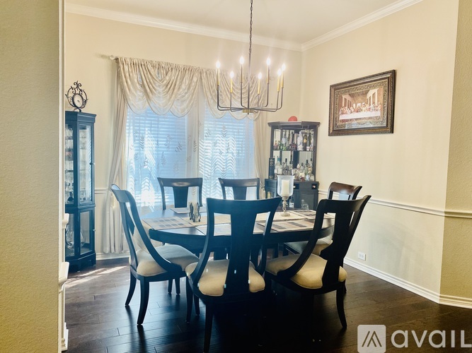A dining room with a table set for four.